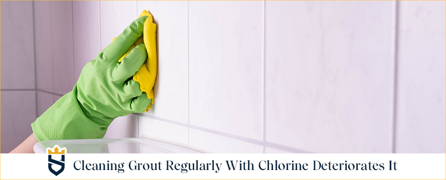 Hand Holding Towel Wiping Shower Tiles and Grout Using Chlorine Which Regular Use May Deteriorate Grout