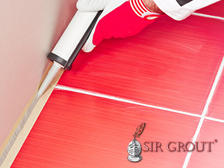 Picture of a Red Tile Floor with White Grout Lines and Caulking