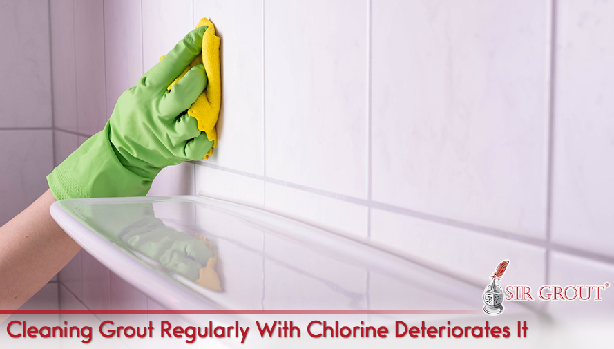 Hand Holding Towel Wiping Shower Tiles and Grout Using Chlorine Which Regular Use May Deteriorate Grout