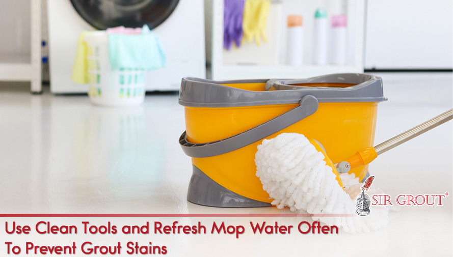 Bucket and Mop Inside Home as Using Clean Tools and Fresh Mop Water Prevents Grout Discoloration